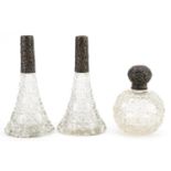 Pair of Edwardian cut glass scent bottles with silver mounts and a globular cut glass scent bottle