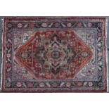 Rectangular Persian rug having an allover floral design onto a predominantly red ground, 240cm x