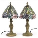 Pair of bronzed Tiffany design table lamps with leaded glass floral shades, each 37.5cm high For