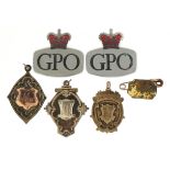 Three silver sports jewels and two GPO enamel badges, the largest 3.5cm wide For further information