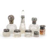 Eight Victorian and later silver mounted cut glass scent bottles and jars, the largest 14cm high For