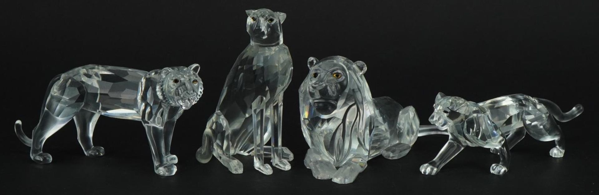 Four Swarovski Crystal big cats including lion and tiger, the largest 14cm in length For further