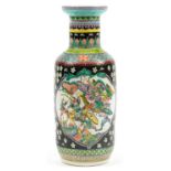 Chinese porcelain black ground rouleau vase hand painted in the famille verte palette with warriors,