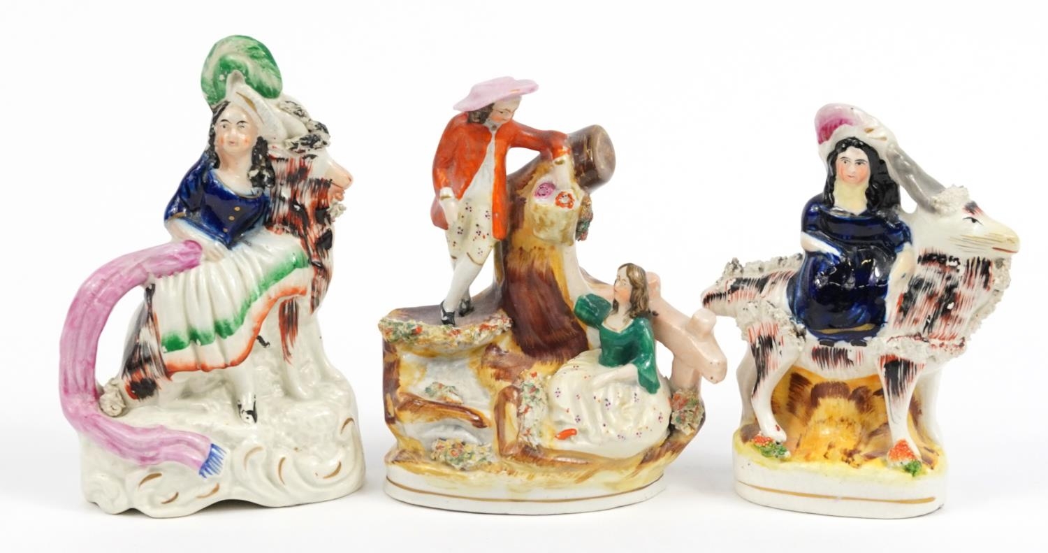 Three Victorian Staffordshire figures including a courting couple and figure on horseback, the