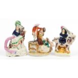 Three Victorian Staffordshire figures including a courting couple and figure on horseback, the