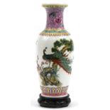 Chinese porcelain vase with carved hardwood stand decorated with a peacock amongst cherry blossom,