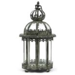 Bronzed metal hanging lantern with glass panels on paw feet, 45.5cm high For further information