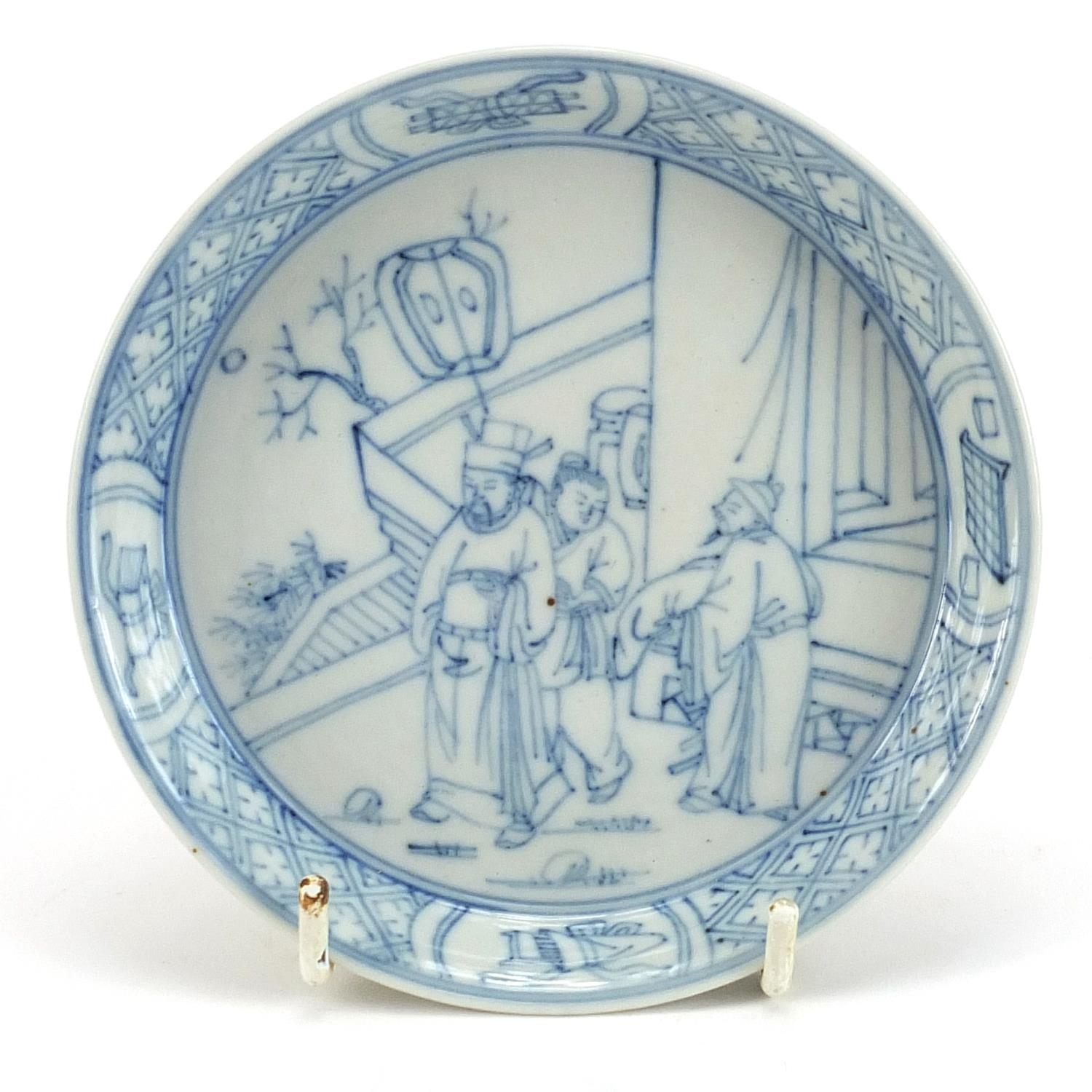 Chinese blue and white porcelain dish hand painted with figures in a palace setting within a