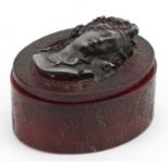 French cherry amber coloured pressed snuff box with lift off lid, decorated in relief with a female,