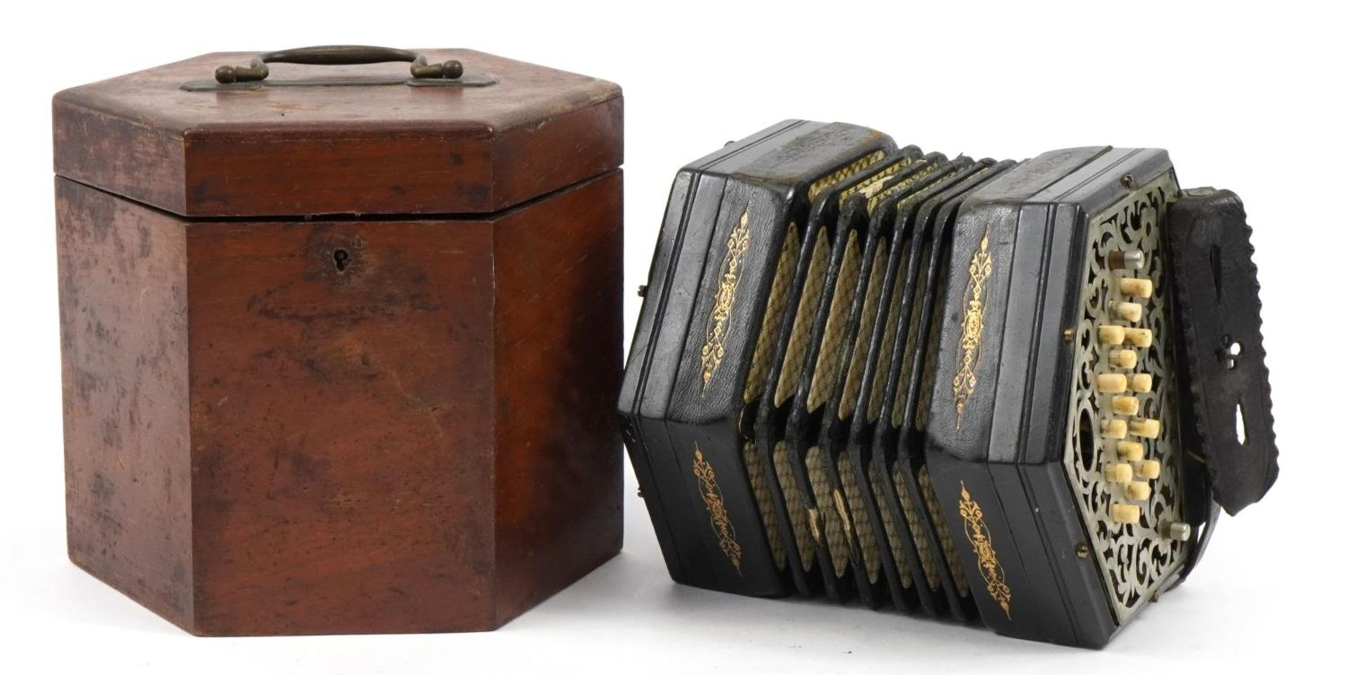 Victorian ebonised thirty two button concertina with pierced metal end plates and velvet lined case,