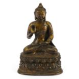 Chino Tibetan partially gilt bronze figure of seated Buddha, character marks to the reverse, 19.