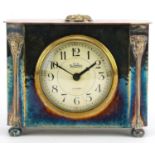George Laurence Connell, Arts & Crafts silver plated mantle clock with masks having a circular