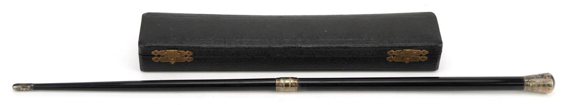 Early 20th century ebonised conductor's baton with engraved silver mounts housed in a velvet and