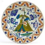 Turkish Ottoman Iznik shallow dish hand painted with a figure wearing traditional dress amongst