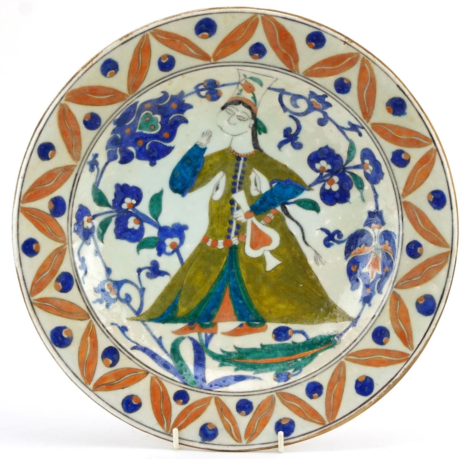 Turkish Ottoman Iznik shallow dish hand painted with a figure wearing traditional dress amongst