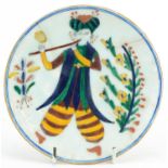 Turkish Ottoman Kutahya plate hand painted with a figure playing an instrument wearing traditional