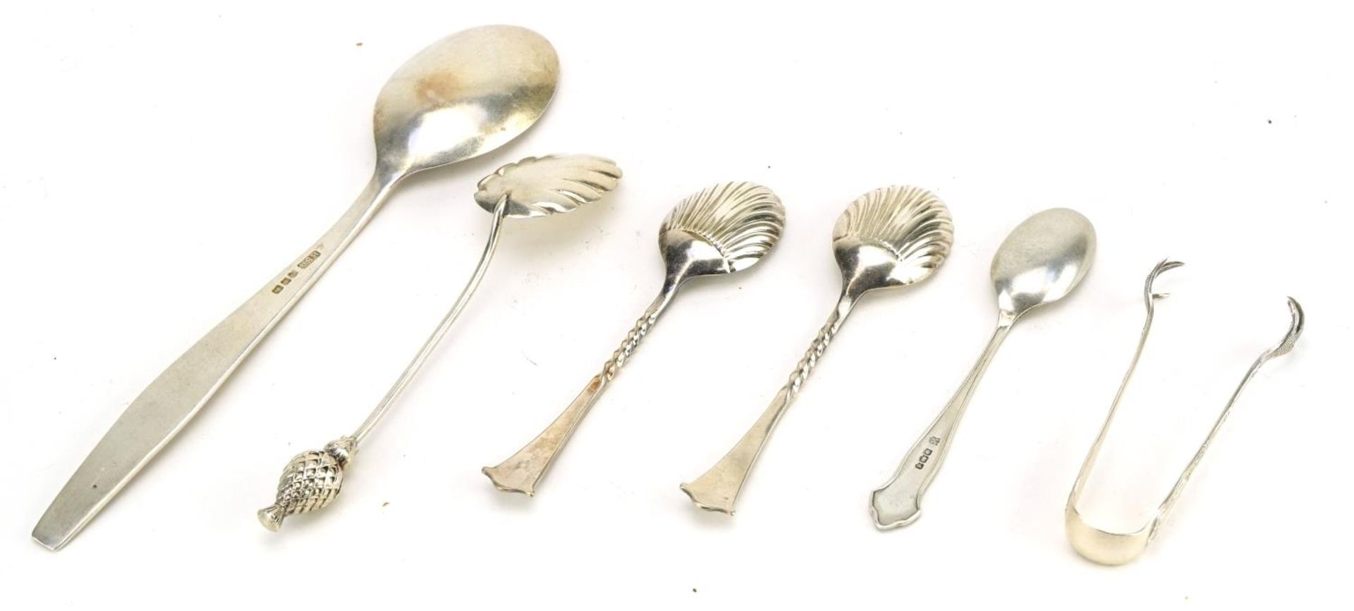 Five silver spoons and a pair of silver sugar tongs, three with shell shaped bowls, the largest 19cm - Image 2 of 3
