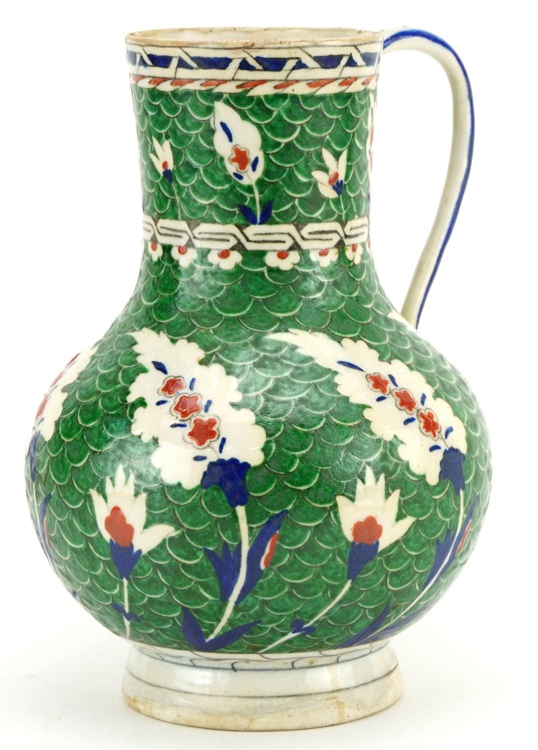 Turkish Iznik Ottoman water jug hand painted with stylised leaves onto a green ground, 26cm high For