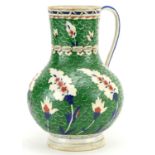 Turkish Iznik Ottoman water jug hand painted with stylised leaves onto a green ground, 26cm high For