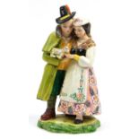Large Italian faience glazed pottery figure group of two figures holding and feeding a lamb,