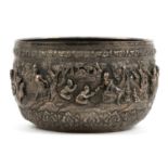 Large Burmese silver bowl profusely embossed with figures and wild animals, 23cm in diameter,