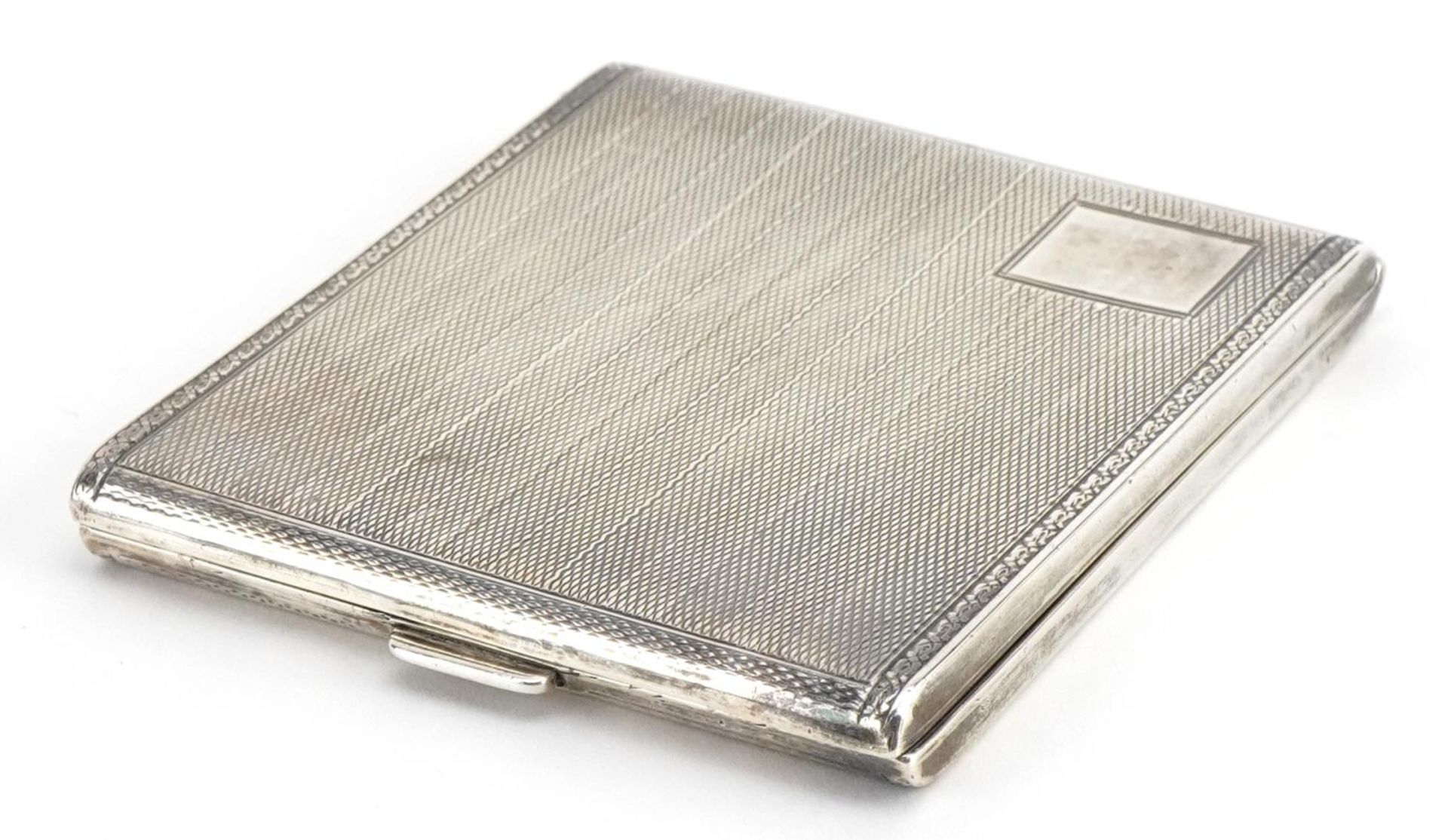 Art Deco rectangular silver cigarette case with engine turned decoration and gilt interior, J H W