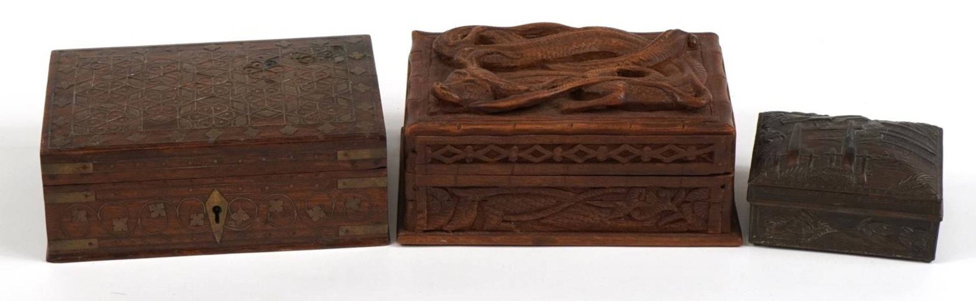 Three oriental and Indian boxes including a hardwood example deeply carved with a dragon and a