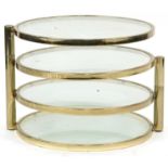 Contemporary gilt metal and glass four tier revolving occasional table, 41.5cm high x 53.5cm in