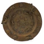 Indian brass plate decorated in relief with various mythical animals and figures, 24.5cm in diameter