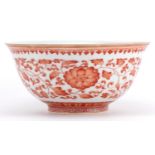 Chinese iron red porcelain bowl hand painted with flower heads amongst scrolling foliage, six figure