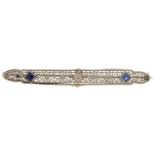 Art Deco unmarked white metal diamond and sapphire filigree bar brooch with safety chain, the