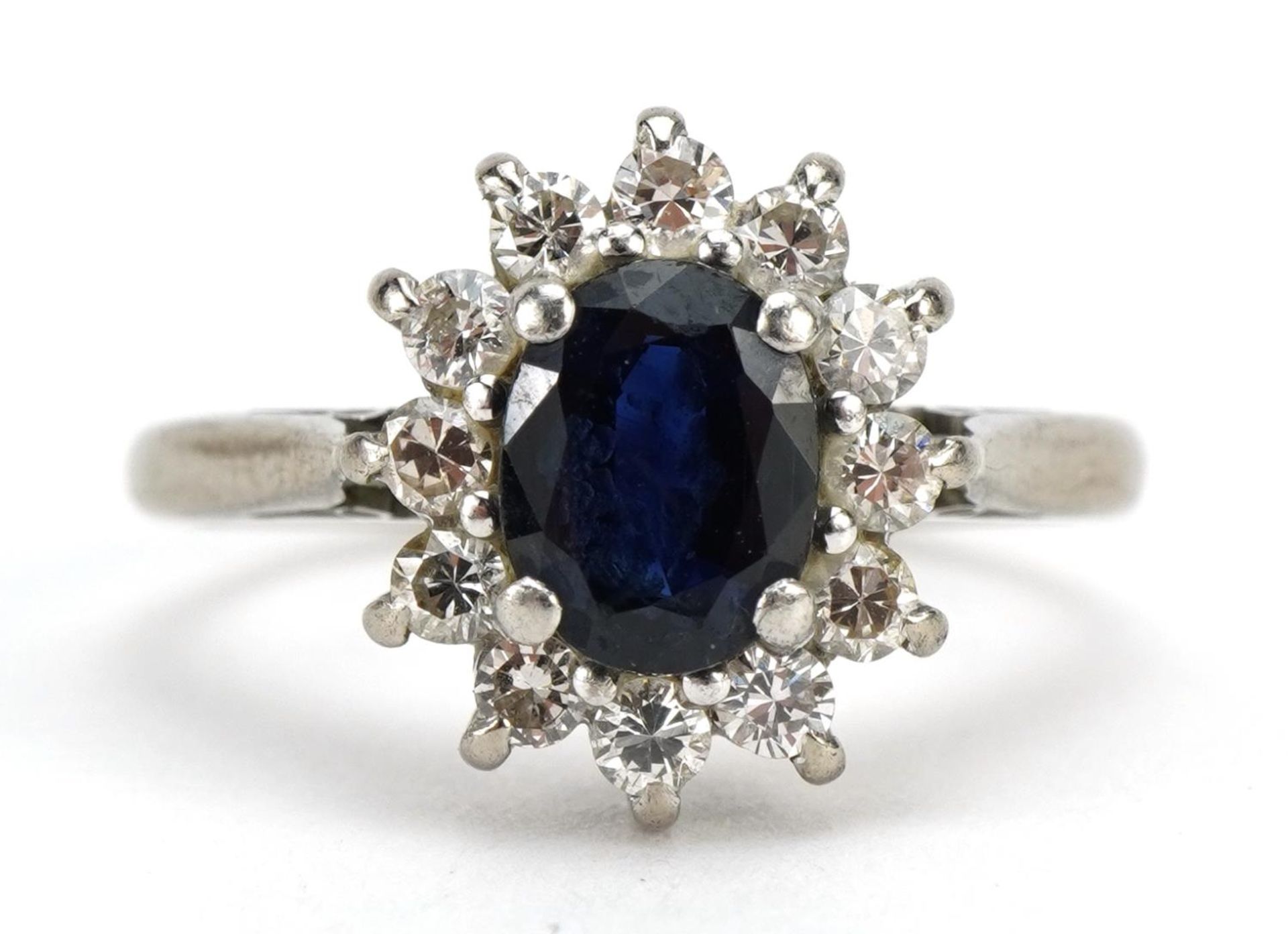 18ct white gold and platinum sapphire and diamond cluster ring, the sapphire approximately 6.8mm x