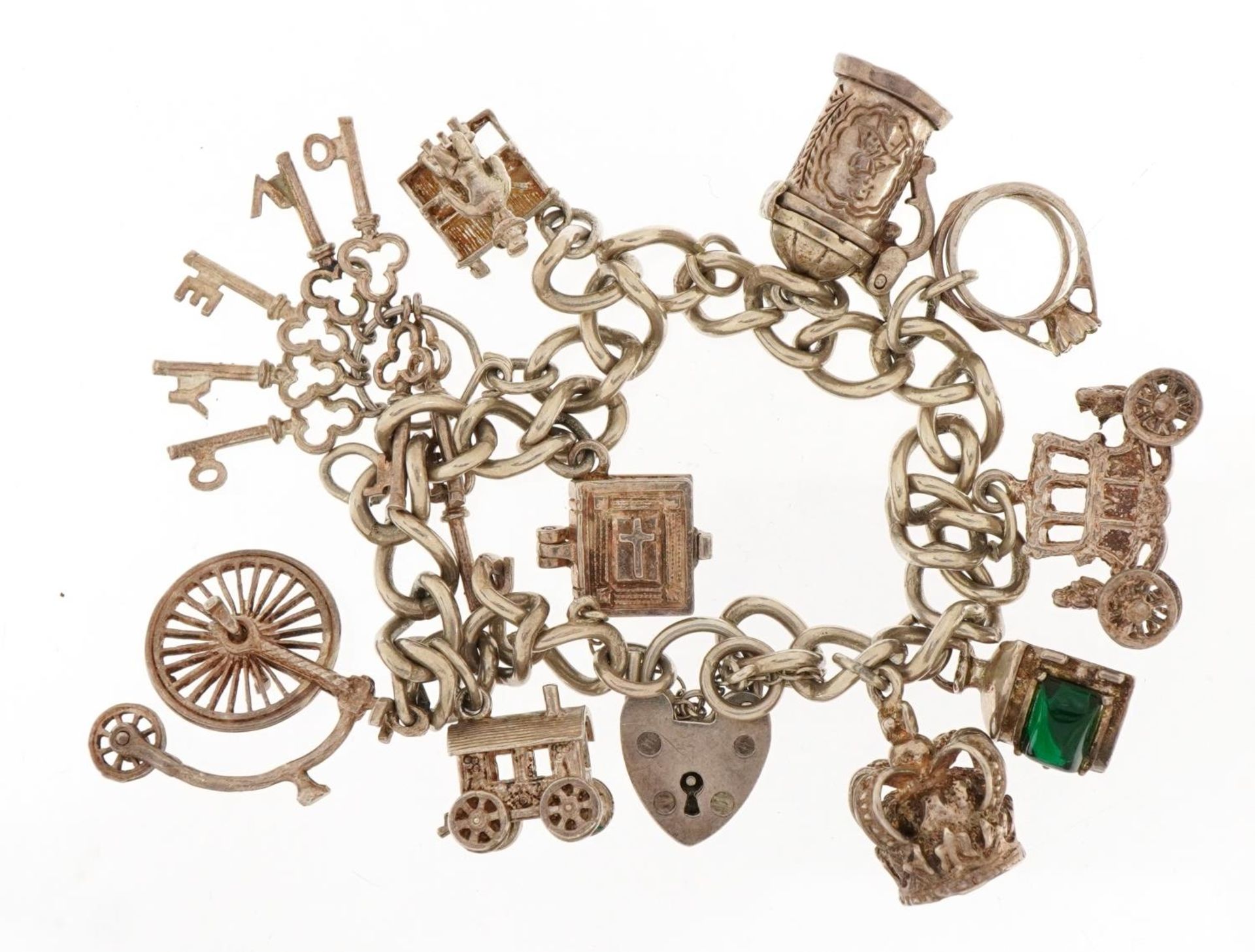 Silver charm bracelet with a selection of mostly silver charms including Penny Farthing, carriage