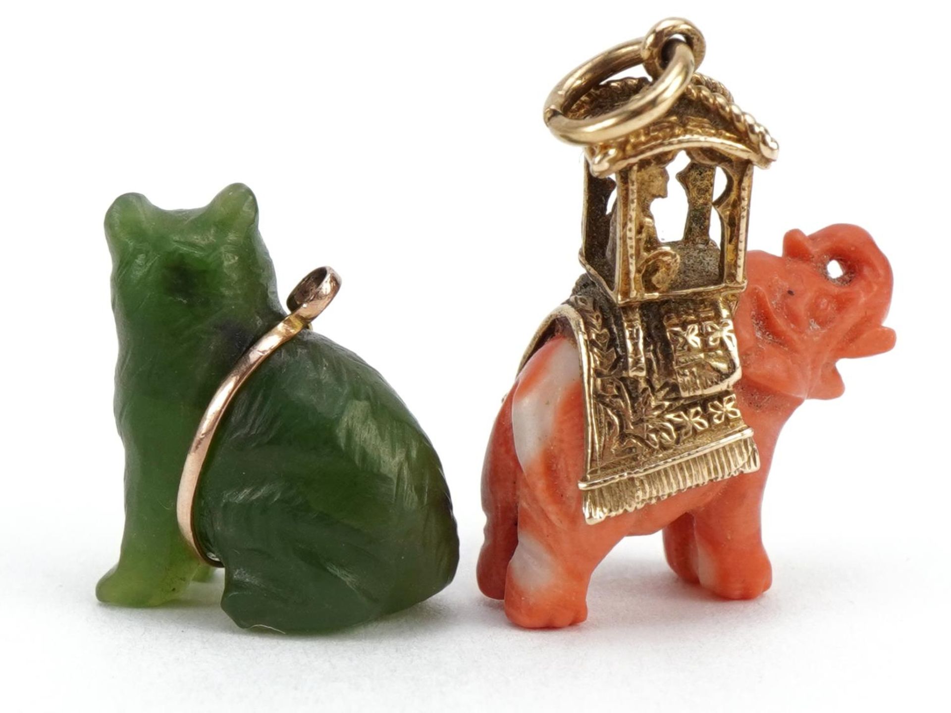 Two Chinese charms comprising carved coral elephant with 9ct gold mount and green stone cat, the - Image 2 of 4