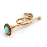 Gold trumpet charm set with a cabochon turquoise, indistinct gold mark, 2.6cm high, 2.0g : For