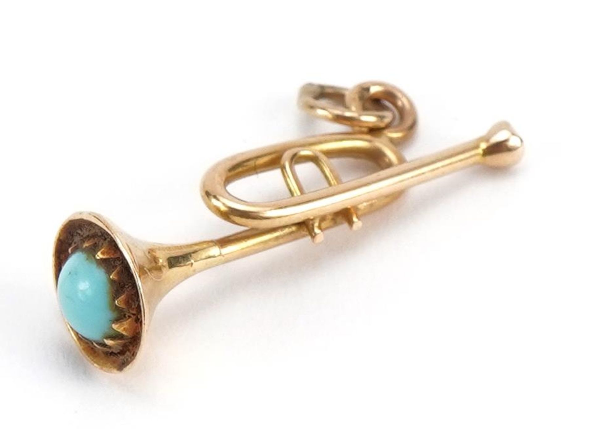 Gold trumpet charm set with a cabochon turquoise, indistinct gold mark, 2.6cm high, 2.0g : For