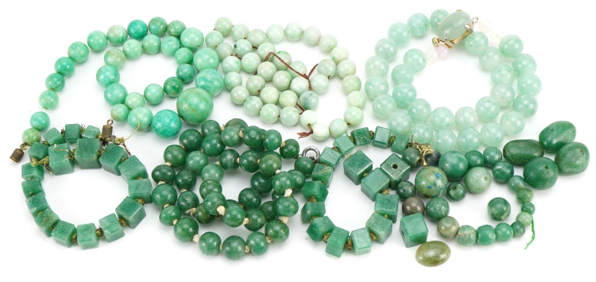 Four Chinese green jade bead necklaces and a collection of loose beads, total weight 350.0g : For