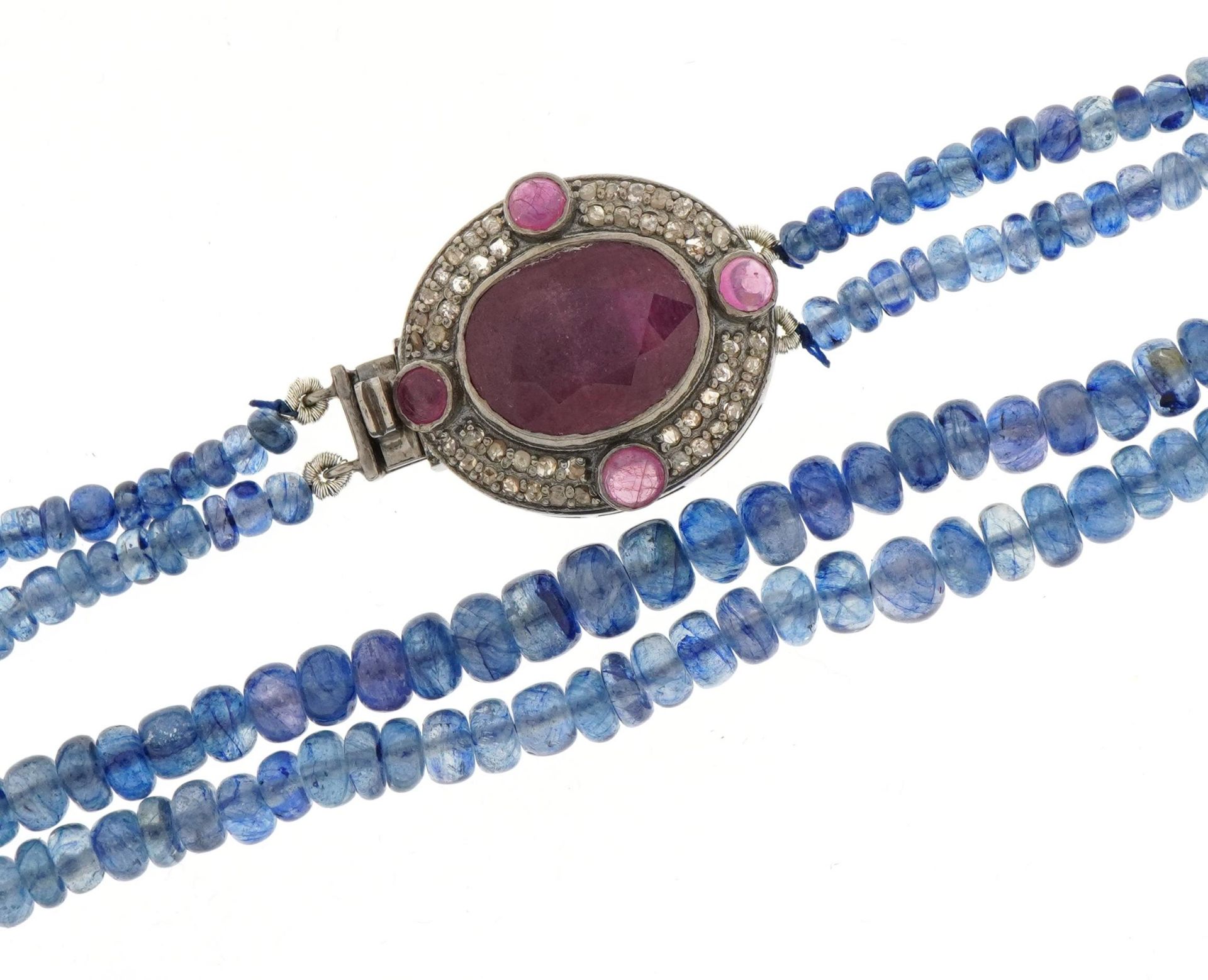 Blue sapphire two line bead necklace with a white metal clasp set with rubies and diamonds, 44cm