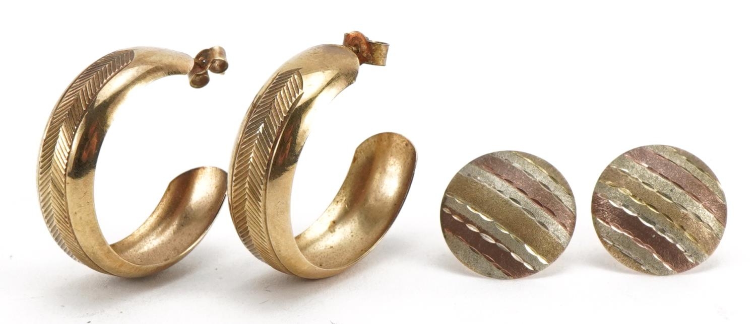 Pair of unmarked three tone gold stud earrings and a pair of 9ct gold hoops, the largest 2.5cm in