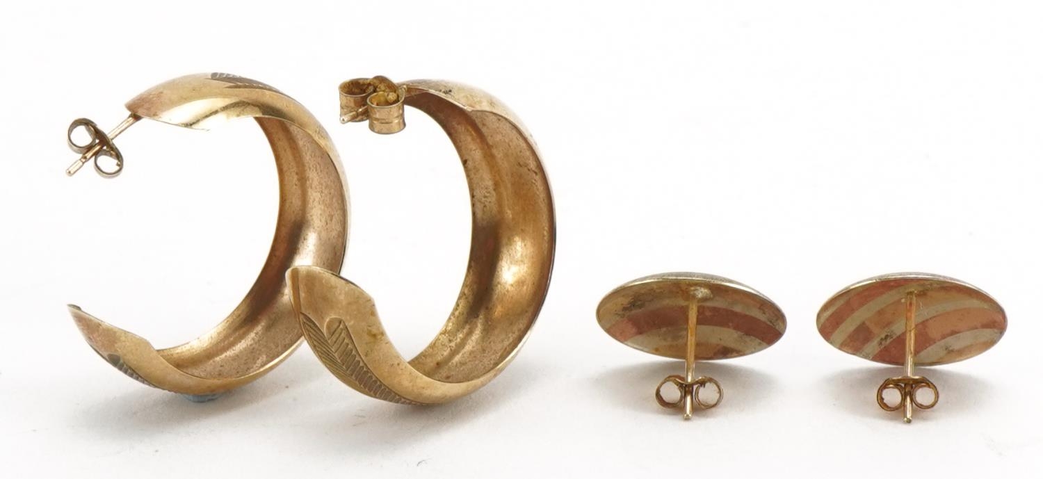 Pair of unmarked three tone gold stud earrings and a pair of 9ct gold hoops, the largest 2.5cm in - Image 2 of 2