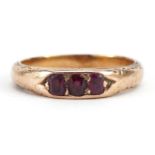 Early 19th century unmarked gold garnet three stone ring with engraved shoulders, tests as 15ct