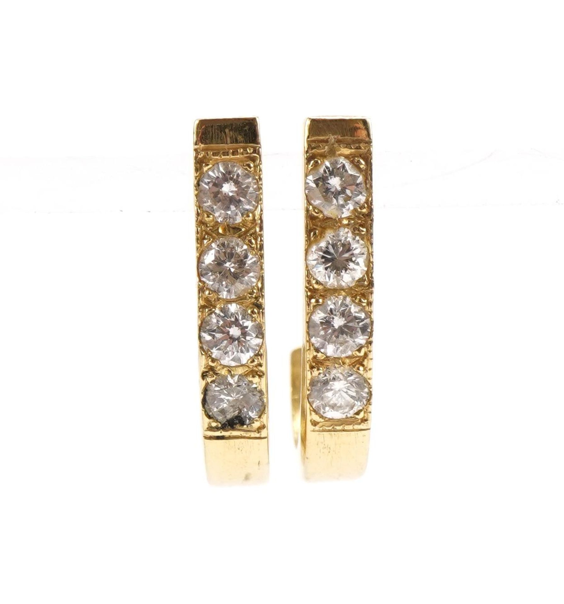 Pair of unmarked gold half hoop earrings, each set with four diamonds, the diamonds each