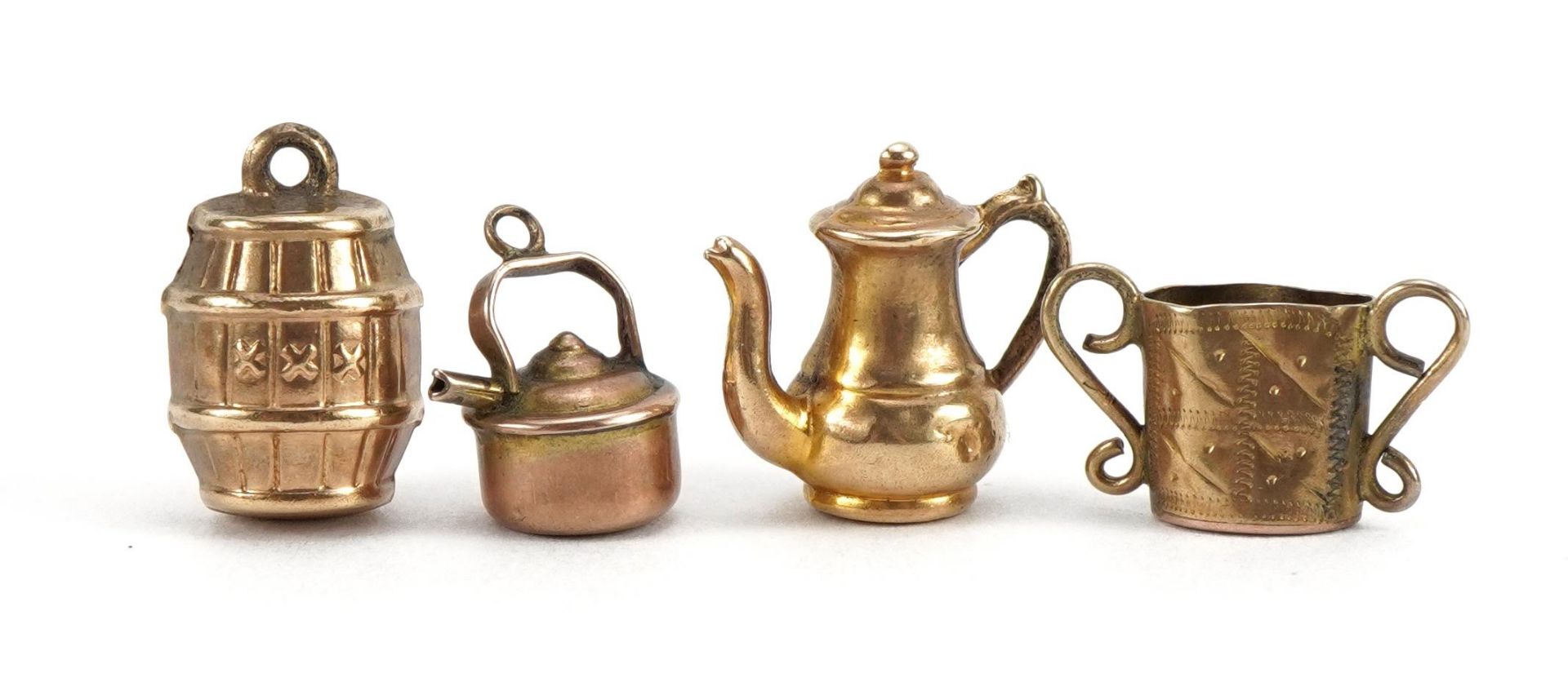 Four 9ct gold charms including gunpowder barrel, teapot and kettle, the largest 1.4cm high, total