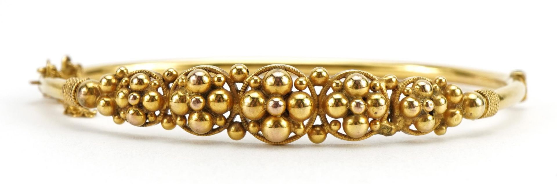 9ct gold flower head design hinged bangle, possibly Edwardian, 6.3cm wide, 6.1g : For further