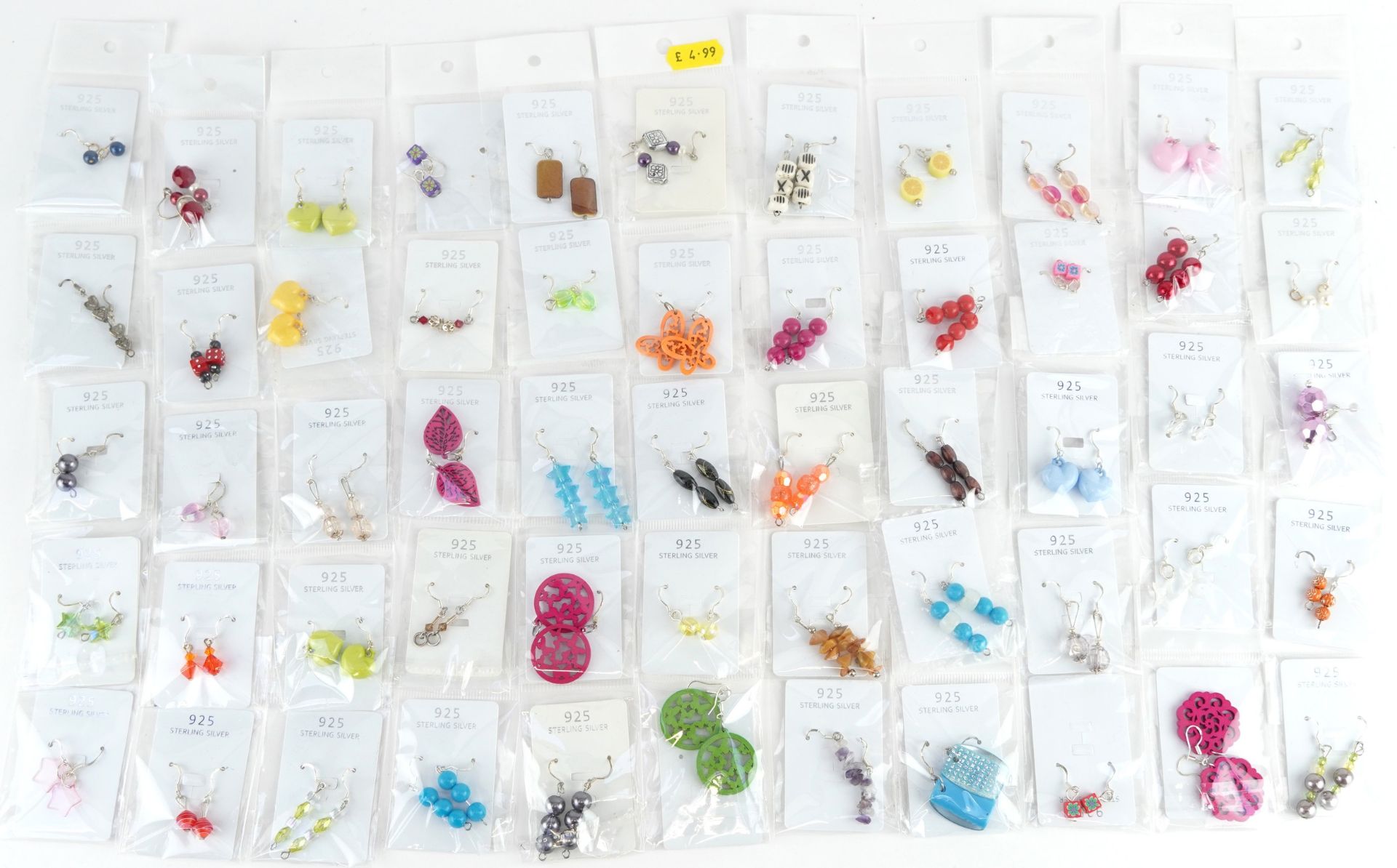 Fifty pairs of silver drop earrings including heart and floral design examples, total