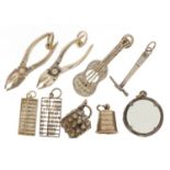 Nine silver charms including pliers, abacus, guitar and drum, the largest 3.2cm high, 19.8g : For