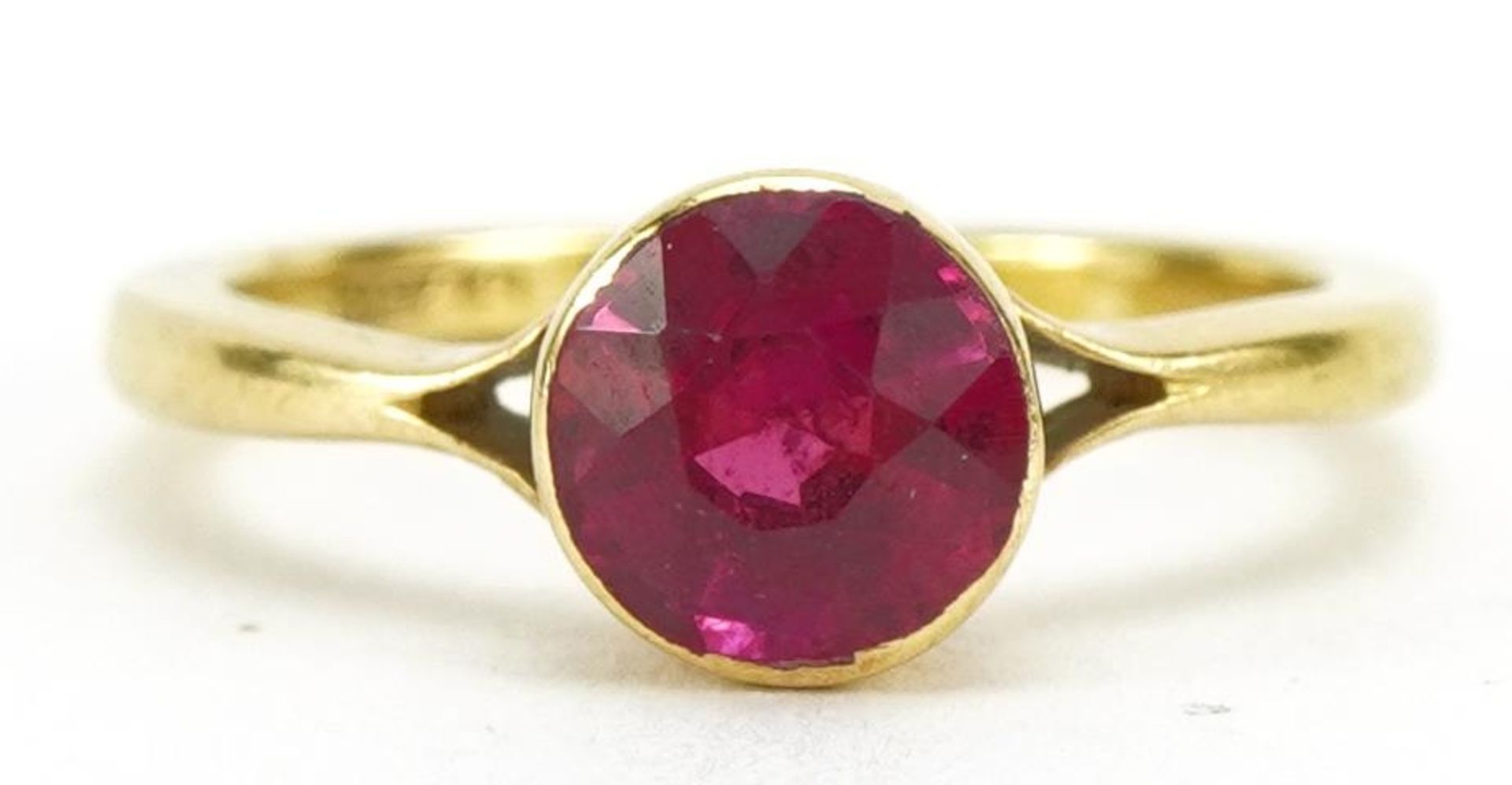 18ct gold ruby solitaire ring, the ruby approximately 5.6mm in diameter, indistinct hallmarks,