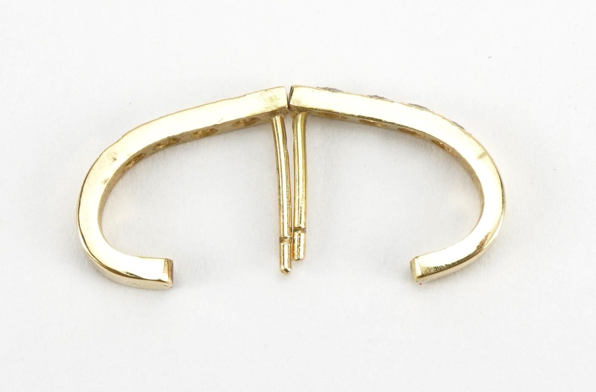 Pair of unmarked gold half hoop earrings, each set with four diamonds, the diamonds each - Image 2 of 2