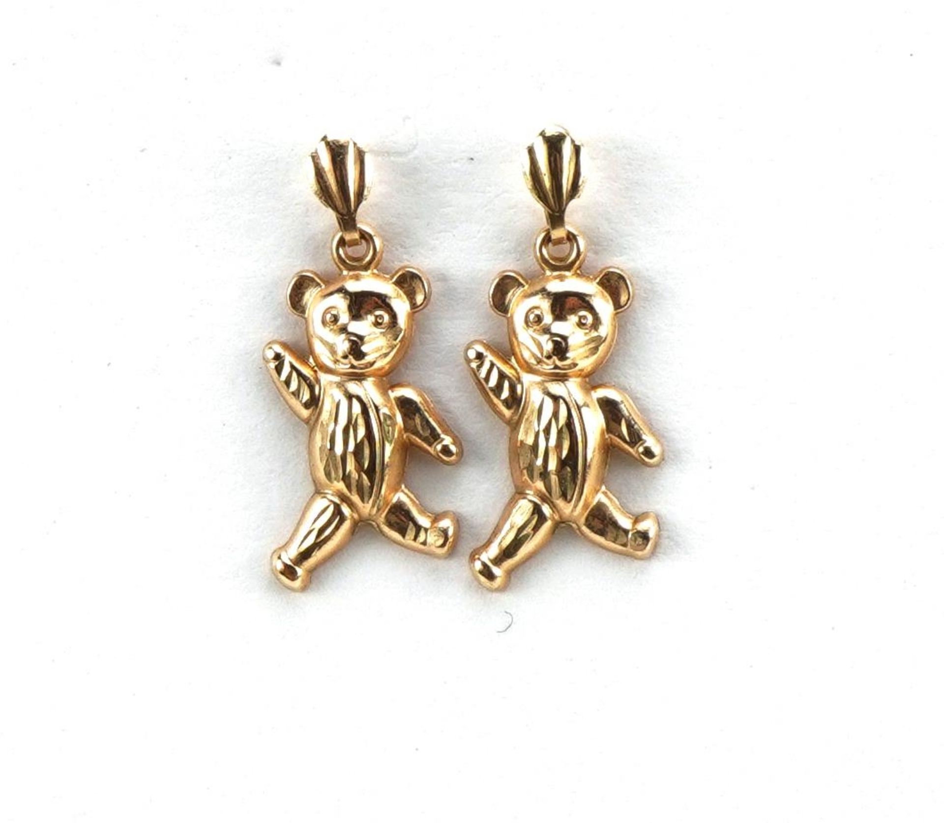 Pair of unmarked gold teddy bear drop earrings, the backs marked 9ct, 2.1cm high, 0.4g : For further