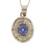 Unmarked white gold sapphire and diamond halo pendant with baguette cut diamonds on a 9ct white gold